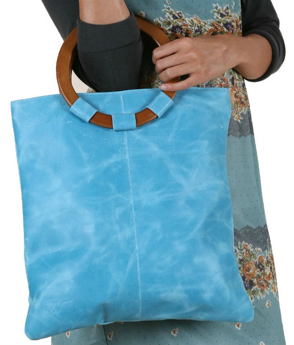 Pale Blue leather bag on model shown in closeup