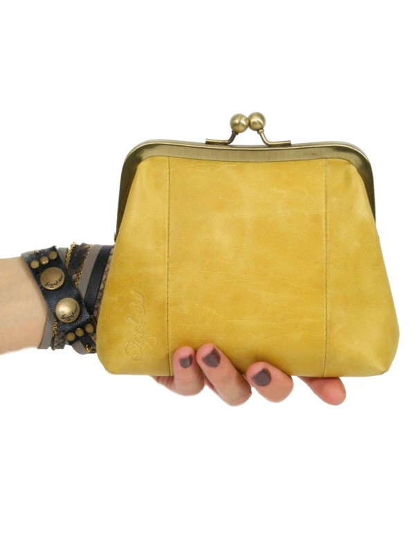 Yellow Sigal Levi clutch purse in hand